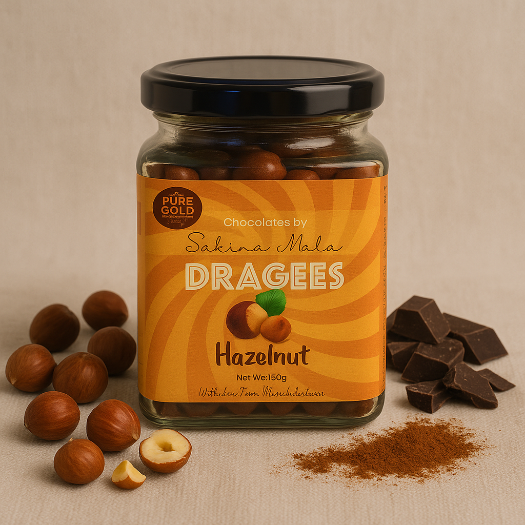 A jar of hazelnut dragees labeled 'Chocolates by Sakina Mala' with scattered hazelnuts and chocolate pieces on a beige background.